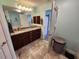 Bright bathroom with dual sinks, granite countertops, and a large mirror at 9175 Melody Cir, Port Charlotte, FL 33981