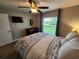 Bright bedroom featuring a ceiling fan and large window at 9175 Melody Cir, Port Charlotte, FL 33981