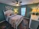 Serene bedroom featuring a queen-sized bed, soft lighting, and a picturesque window view at 9175 Melody Cir, Port Charlotte, FL 33981