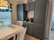 Inviting dining area features built in gray accent cabinets and a coffee bar at 9175 Melody Cir, Port Charlotte, FL 33981