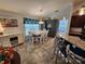 Inviting dining area with a white table, gray accent cabinets, and stylish floral valance at 9175 Melody Cir, Port Charlotte, FL 33981