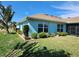 This home showcases a landscaped yard with colorful plants and shrubs highlighting the outdoor space at 9175 Melody Cir, Port Charlotte, FL 33981