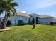 Single-story home with a well-manicured lawn and landscaping creating great curb appeal at 9175 Melody Cir, Port Charlotte, FL 33981