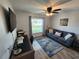 Cozy living room with a comfortable blue sofa, stylish rug, and a mounted television at 9175 Melody Cir, Port Charlotte, FL 33981