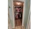 Walk-in closet with abundant storage, including multiple rods and overhead shelving at 9175 Melody Cir, Port Charlotte, FL 33981