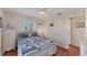 Bright bedroom featuring nautical themed bedding, and wood flooring at 92 Circlewood Dr # B3-1, Venice, FL 34293