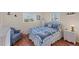 Comfortable bedroom with nautical themed bedding, chair, and wood flooring at 92 Circlewood Dr # B3-1, Venice, FL 34293