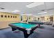 Billiard Room with pool tables, windows for natural light, and seating area at 92 Circlewood Dr # B3-1, Venice, FL 34293