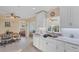 Well-lit kitchen with white cabinets, marble countertops, and tile flooring at 92 Circlewood Dr # B3-1, Venice, FL 34293