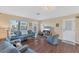 Well-lit living room featuring wood floors, comfortable seating, and a view of the outdoors at 92 Circlewood Dr # B3-1, Venice, FL 34293