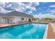 Sparkling community pool with lounge chairs, set against a backdrop of blue skies and white clouds at 92 Circlewood Dr # B3-1, Venice, FL 34293