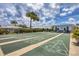 Outdoor shuffleboard courts ready for play, set amongst lush greenery and bright blue skies at 92 Circlewood Dr # B3-1, Venice, FL 34293