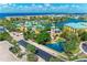 An aerial view of a waterfront community with condos, a pool, and a scenic waterway at 93 Vivante Blvd # 9336, Punta Gorda, FL 33950