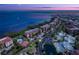 Beautiful aerial view of waterfront condominiums with tennis courts and a pool during twilight at 93 Vivante Blvd # 9336, Punta Gorda, FL 33950