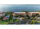 Scenic aerial view of resort-style residences with ocean views, mature trees, and a community pool at 93 Vivante Blvd # 9336, Punta Gorda, FL 33950