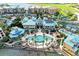 Aerial perspective of the community clubhouse and pool, surrounded by palm trees and lush greenery at 93 Vivante Blvd # 9336, Punta Gorda, FL 33950