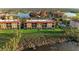 Aerial view of a community with tile roofed buildings, lakes and green spaces at 93 Vivante Blvd # 9336, Punta Gorda, FL 33950