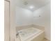 Bathroom with jacuzzi style tub and tile surround at 93 Vivante Blvd # 9336, Punta Gorda, FL 33950