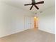 Carpeted bedroom featuring a ceiling fan, closet, and neutral paint for a calm space at 93 Vivante Blvd # 9336, Punta Gorda, FL 33950