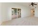 Neutral bedroom with balcony access via sliding glass doors and ceiling fan at 93 Vivante Blvd # 9336, Punta Gorda, FL 33950