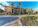 Attractive building exterior with private balconies, lush greenery, and convenient covered parking at 93 Vivante Blvd # 9336, Punta Gorda, FL 33950