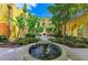 Lush courtyard with mature trees, tropical plants, and a central fountain creates a peaceful oasis at 93 Vivante Blvd # 9336, Punta Gorda, FL 33950