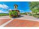 A gated community entrance with lush landscaping and brick-paved roads at 93 Vivante Blvd # 9336, Punta Gorda, FL 33950