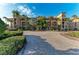 Elegant condominium with a brick driveway, lush landscaping, and private balconies at 93 Vivante Blvd # 9336, Punta Gorda, FL 33950