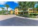 Elegant yellow condominium with manicured landscaping and a circular driveway at 93 Vivante Blvd # 9336, Punta Gorda, FL 33950