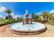 Ornate tiered fountain as the focal point, enhanced by lush landscaping in a garden setting at 93 Vivante Blvd # 9336, Punta Gorda, FL 33950