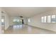 Airy living room with tile floors, a ceiling fan, and sliding glass doors to a screened balcony at 93 Vivante Blvd # 9336, Punta Gorda, FL 33950