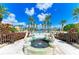 Decorative fountain at the community swimming pool surrounded by palm trees at 93 Vivante Blvd # 9336, Punta Gorda, FL 33950