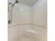 Walk-in shower with white tile surround and built-in bench at 93 Vivante Blvd # 9336, Punta Gorda, FL 33950