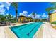 Stunning lap pool with clear blue water, palm trees, and comfortable lounge chairs for relaxing poolside at 93 Vivante Blvd # 9336, Punta Gorda, FL 33950