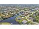 Picturesque aerial view of waterfront properties with lush greenery, private docks, and access to winding canals at 9428 Bandera Ln, Port Charlotte, FL 33981