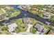 Wide angle aerial view of neighborhood showcasing single Gathering homes on waterfront lots and canals at 9428 Bandera Ln, Port Charlotte, FL 33981