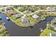 Overhead view of waterfront home, showcasing private dock, lush landscaping, and serene canal access at 9428 Bandera Ln, Port Charlotte, FL 33981