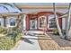 Inviting home entrance with attractive architecture, decorative columns, arched windows, and well-maintained landscaping at 9428 Bandera Ln, Port Charlotte, FL 33981