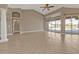 Open living room with tile floors, high ceilings, and large sliders leading to backyard pool at 9428 Bandera Ln, Port Charlotte, FL 33981