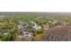 Expansive aerial view of a single-story home with a pool, set amidst lush greenery and mature trees at 9505 Delray Dr, New Port Richey, FL 34654