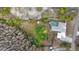 Overhead view of home with private pool nestled amid lush greenery and mature trees at 9505 Delray Dr, New Port Richey, FL 34654