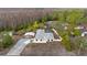 Aerial view of the charming home, showcasing a private pool and expansive driveway at 9505 Delray Dr, New Port Richey, FL 34654