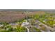 A sprawling aerial view captures a single-story home with a pool, complemented by lush greenery and mature trees at 9505 Delray Dr, New Port Richey, FL 34654