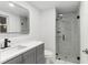 A modern bathroom features a frameless glass shower and sleek vanity at 9505 Delray Dr, New Port Richey, FL 34654