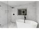 Spa-like bathroom features soaking tub, glass shower, and tile surround at 9505 Delray Dr, New Port Richey, FL 34654