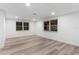 Bright bedroom featuring wood-style flooring and ample natural light from two windows at 9505 Delray Dr, New Port Richey, FL 34654