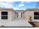 Welcoming front entrance featuring a white front door and modern outdoor lighting fixtures at 9505 Delray Dr, New Port Richey, FL 34654