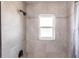 Shower featuring gray tile, black fixtures, and a frosted glass window at 11176 3Rd Ave, Punta Gorda, FL 33955