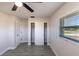 Bedroom featuring plank flooring, closet with shelving, and a window providing ample natural light at 11176 3Rd Ave, Punta Gorda, FL 33955