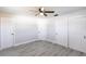 Bright bedroom boasts gray plank flooring, ceiling fan, and closet for ample storage at 11176 3Rd Ave, Punta Gorda, FL 33955